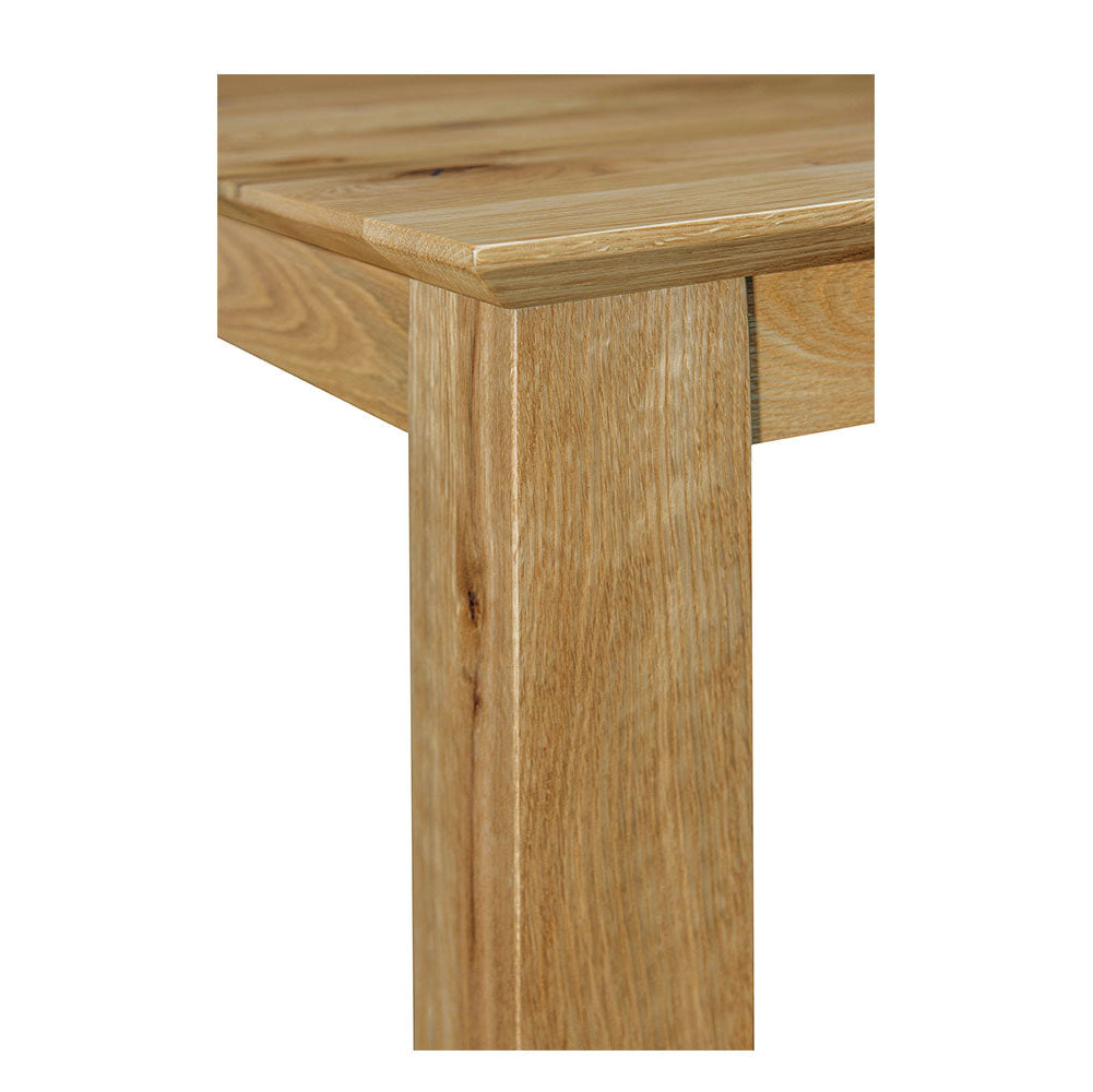 Close-up of a wooden table leg on a white background