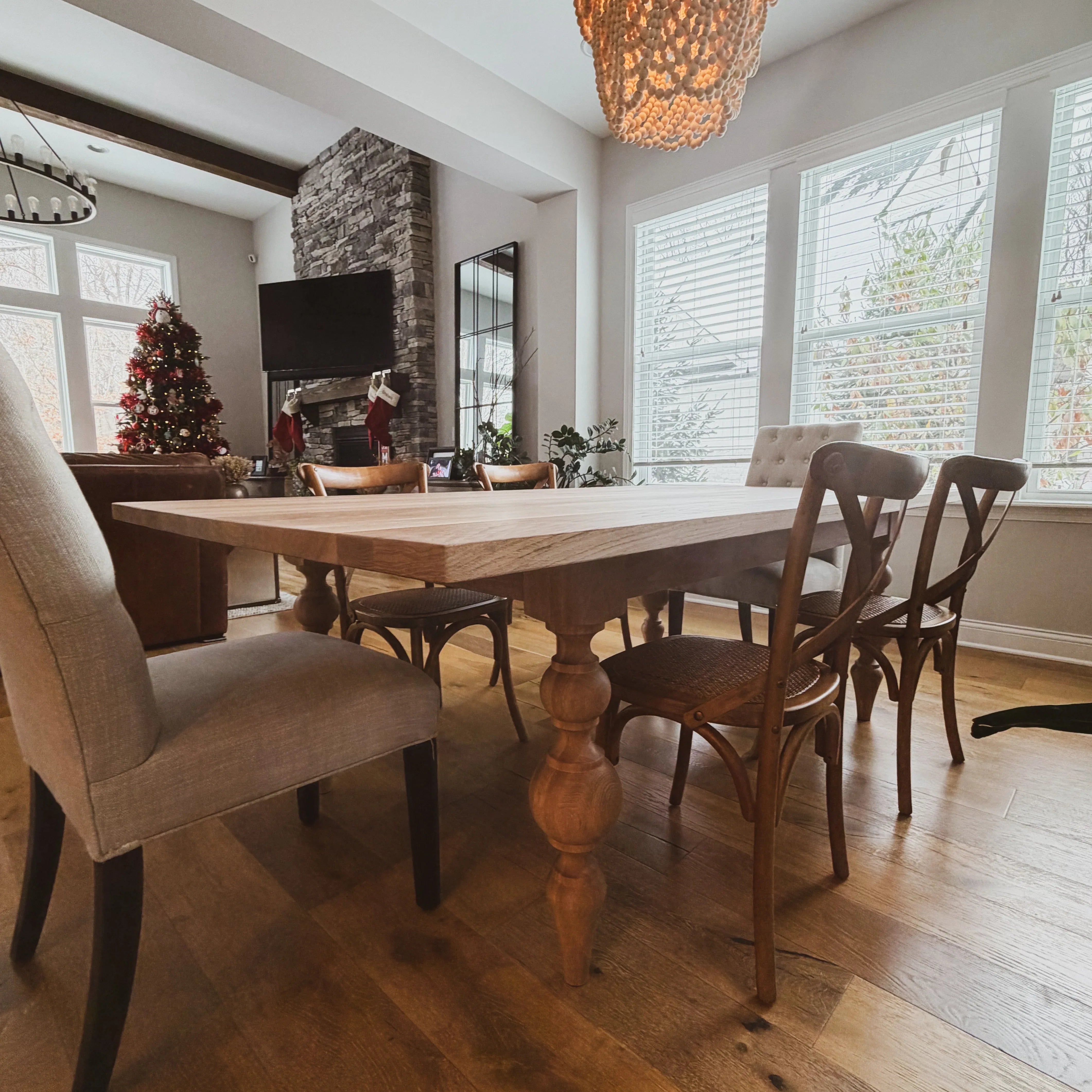 Dining room with wooden table and chairs in a well-lit room.